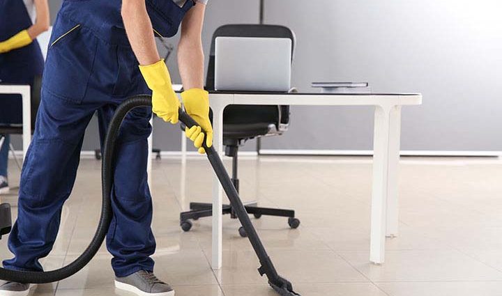 Professional Floor Care NY spanier; Janitor hoovering floor in office