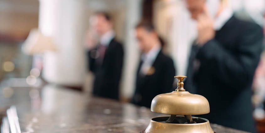 How Concierge Services Drive Customer Loyalty and Repeat Business; Hotel service bell Concept hotel, travel, room,Modern luxury hotel reception counter desk on background